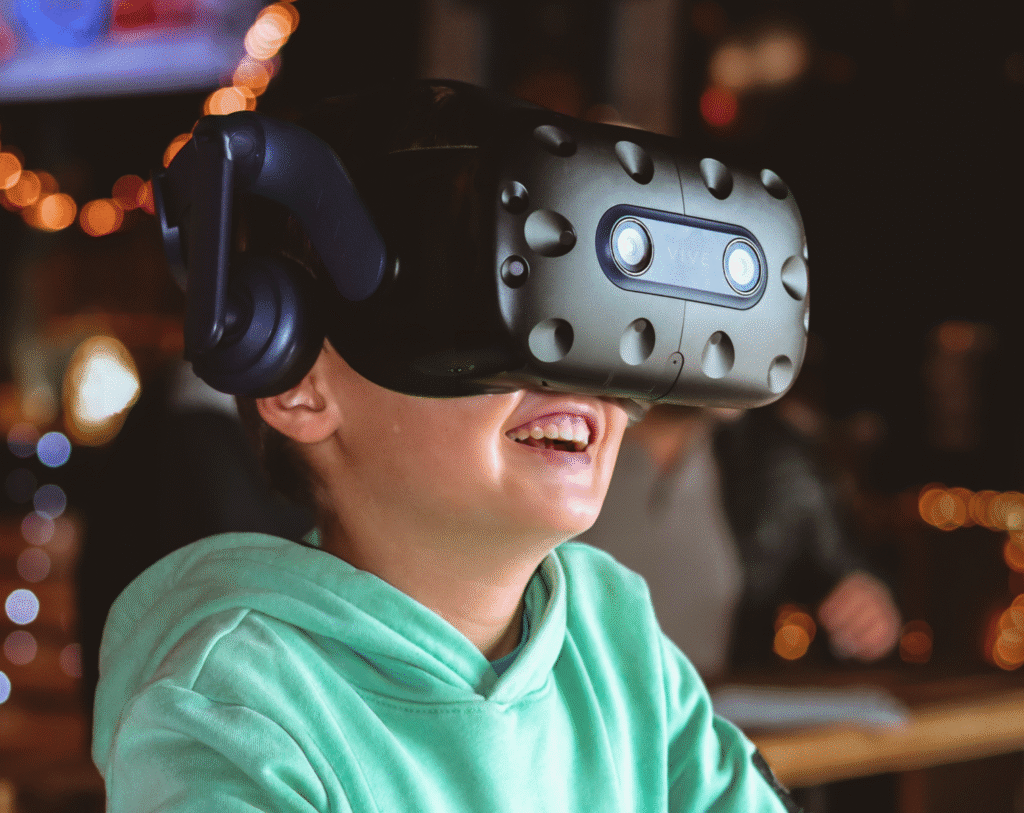 Enfant souriant avec un casque de réalité virtuelle.